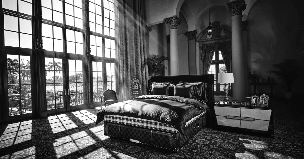The Hästens Grand Vividus bed in its signature check, styled for the Wayne Gretzky campaign